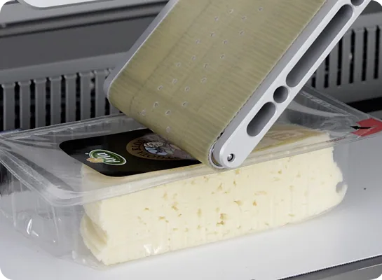 Evolabel applicator brengt een etiket aan op een kaasverpakking